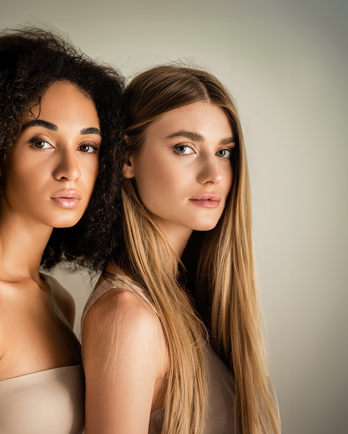 Diverse models posing together with natural makeup.