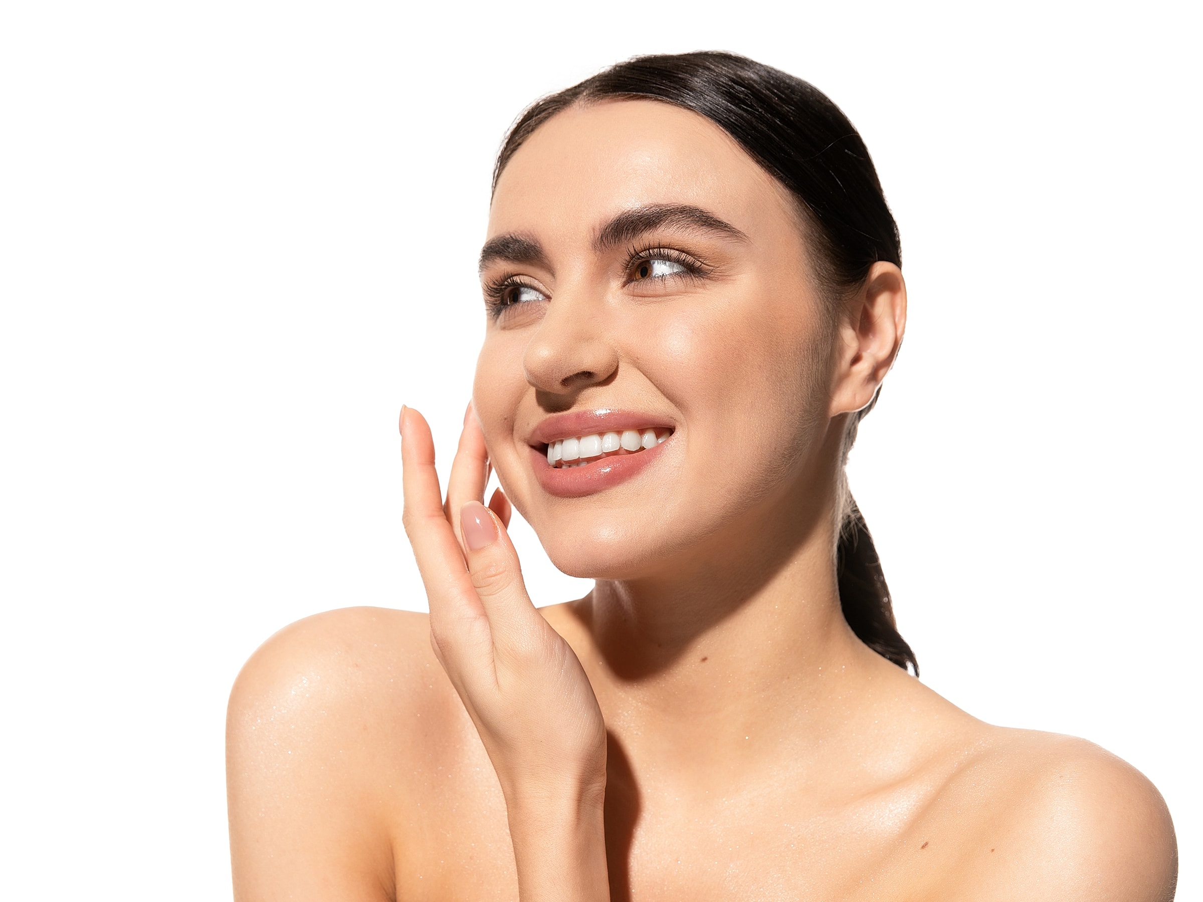 Smiling woman with glowing skin and hand.